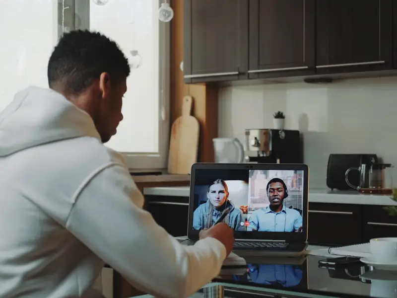 Business manager conducting video interview with diverse international candidates showcasing global remote hiring process