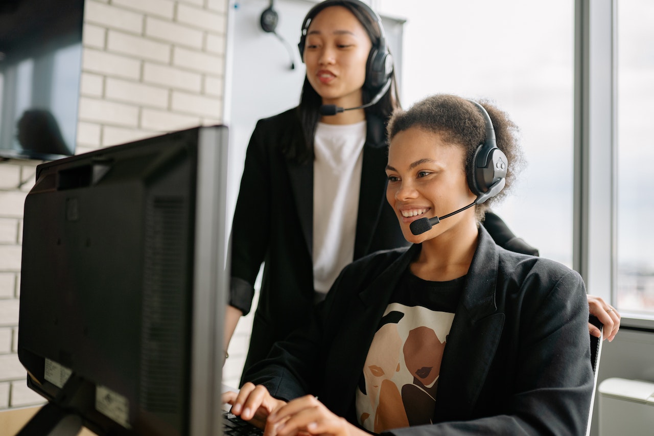 Two customer service reps handle a call