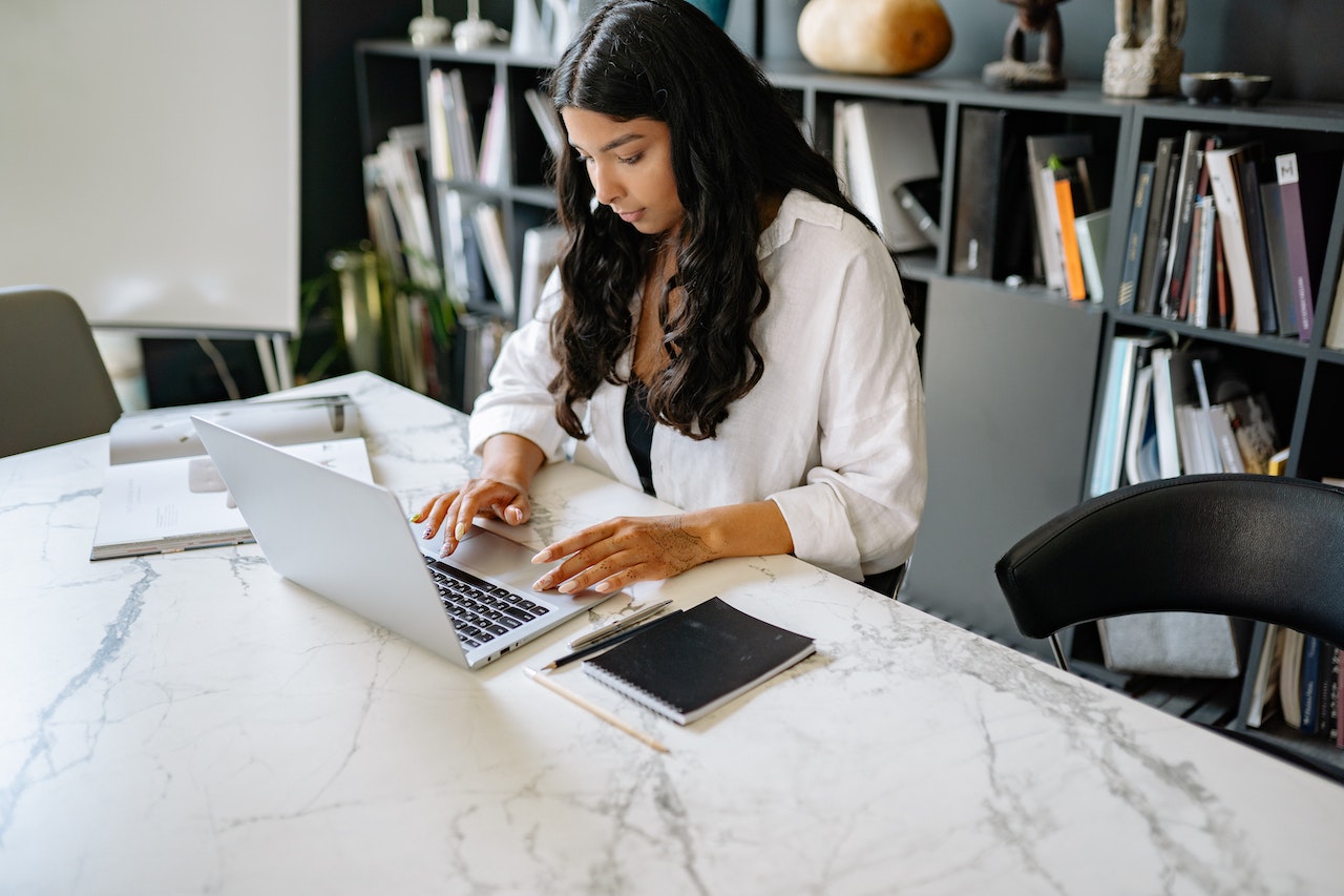 A woman types on her computer