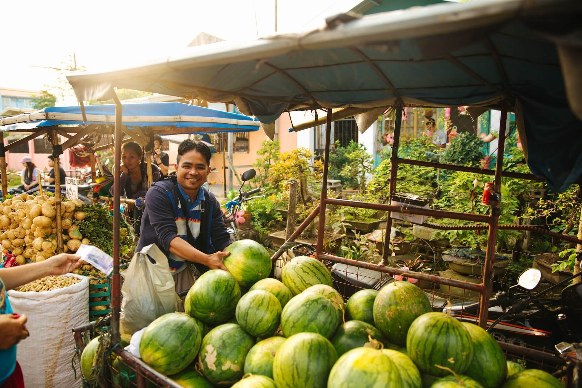 A Filipino watermelon seller smiling to the camera