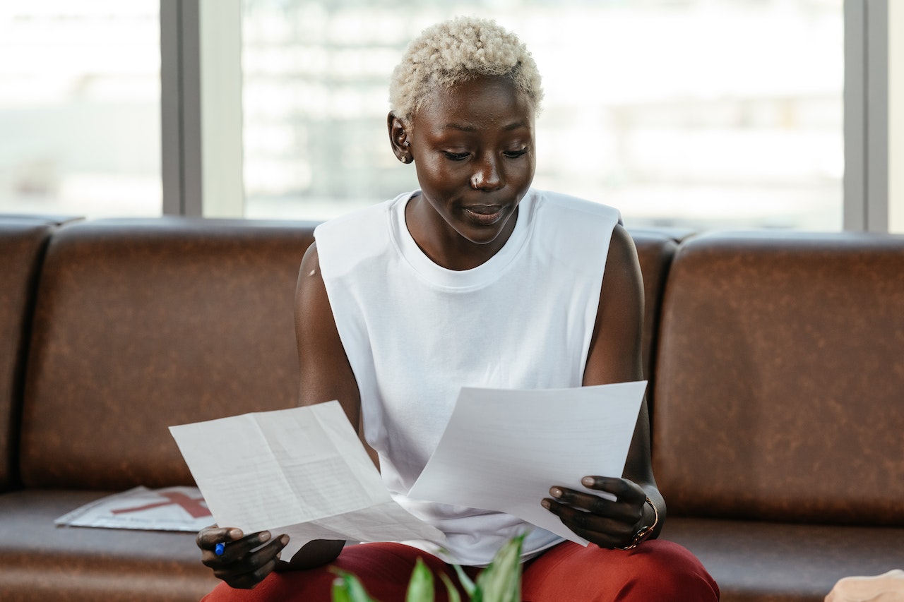 A woman evaluates her employees through printed evaluation sheets