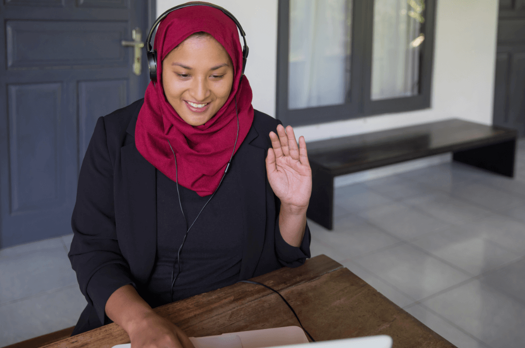 A person of color is being interviewed online for a remote job.