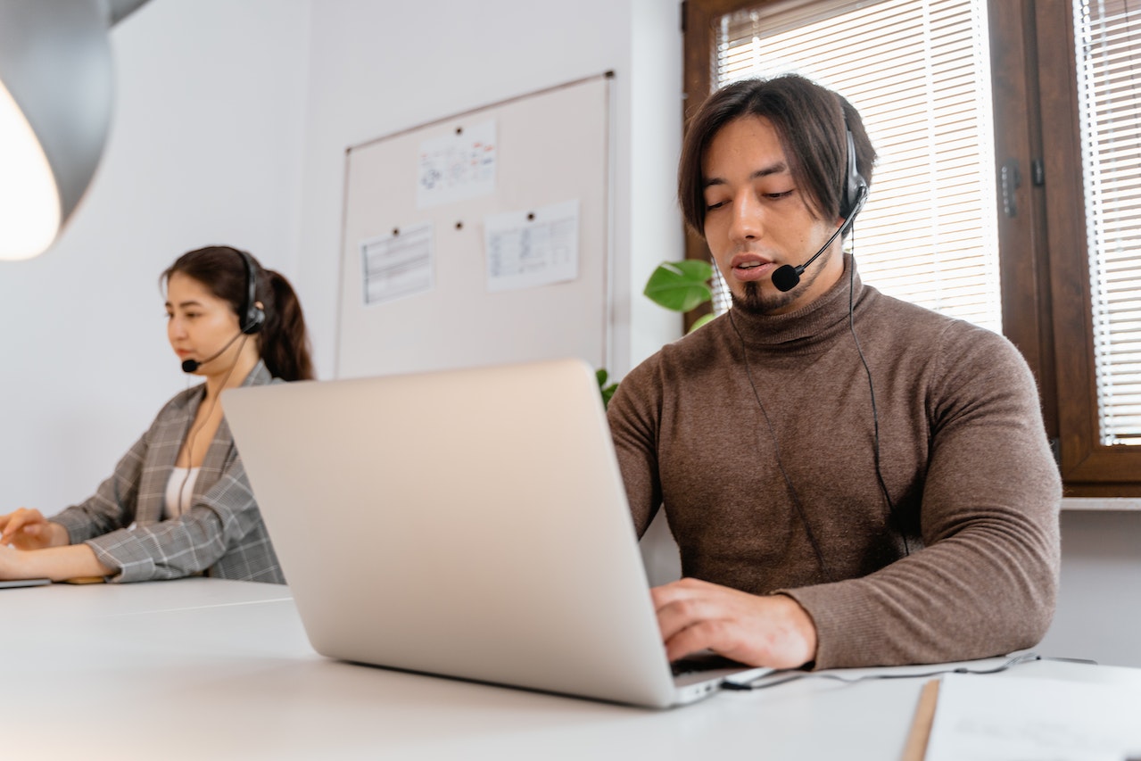 Two customer service representatives working in an office