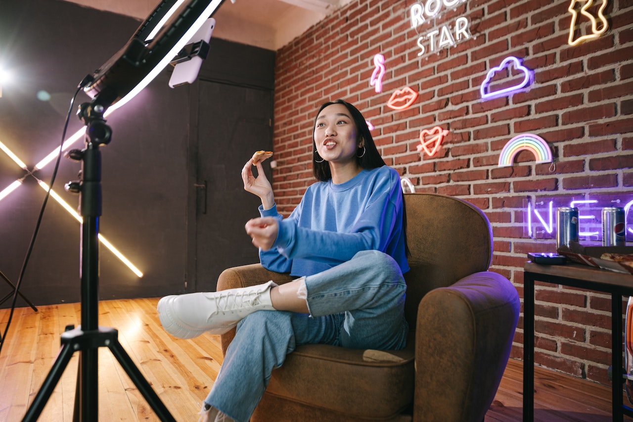 A content creator in their studio, shooting a video in front of a ringlight