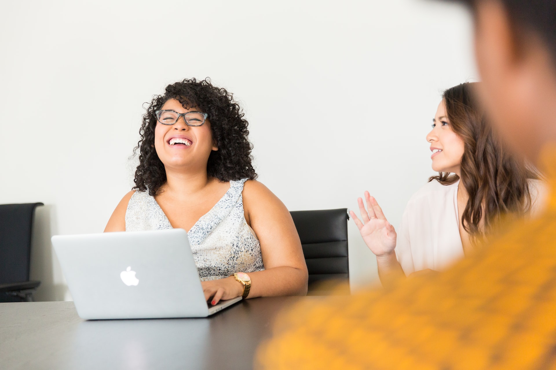 A woman laughing with her office mates