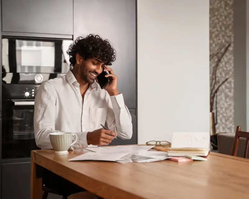 Professional conducting recruitment calls and taking notes demonstrating RPO screening process for scaling teams