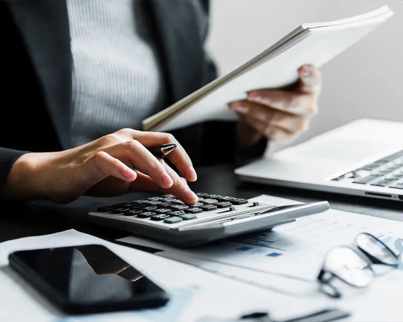 Global bookkeeper calculating P&L reports to provide real-time financial clarity through Somewhere's talent network
