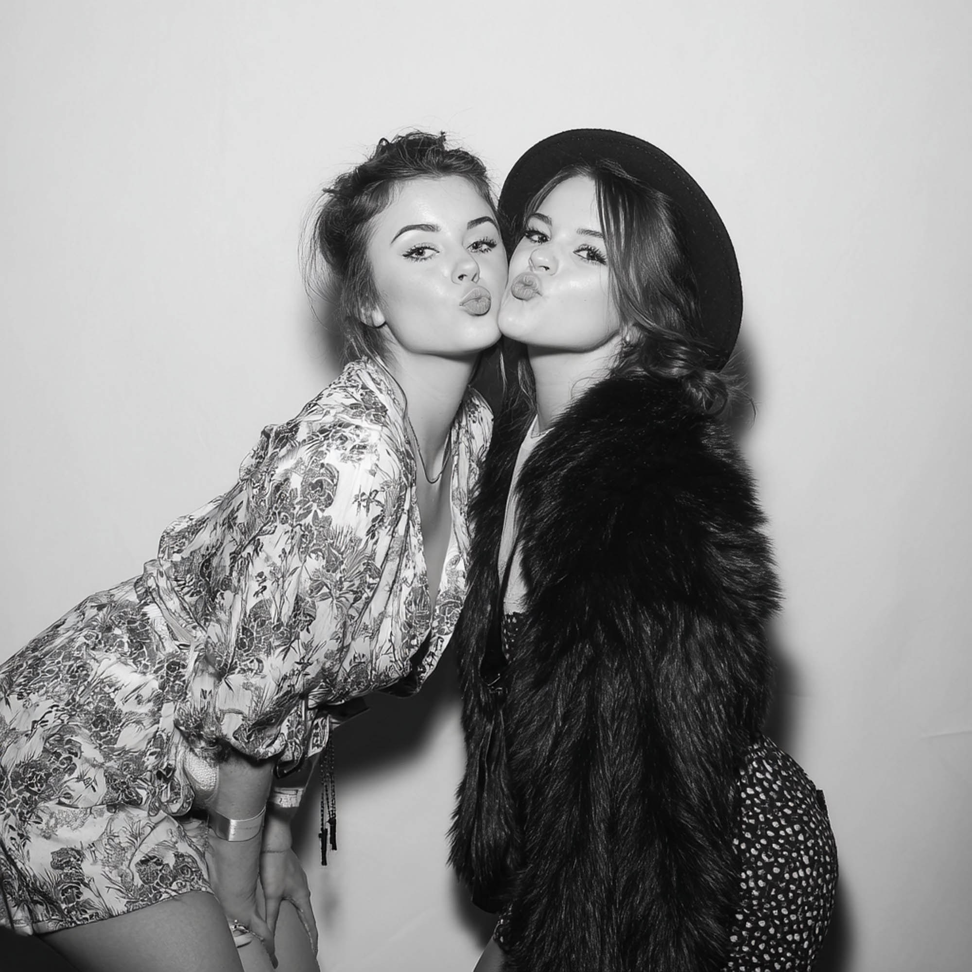 Black and white photo booth portrait of two women posing