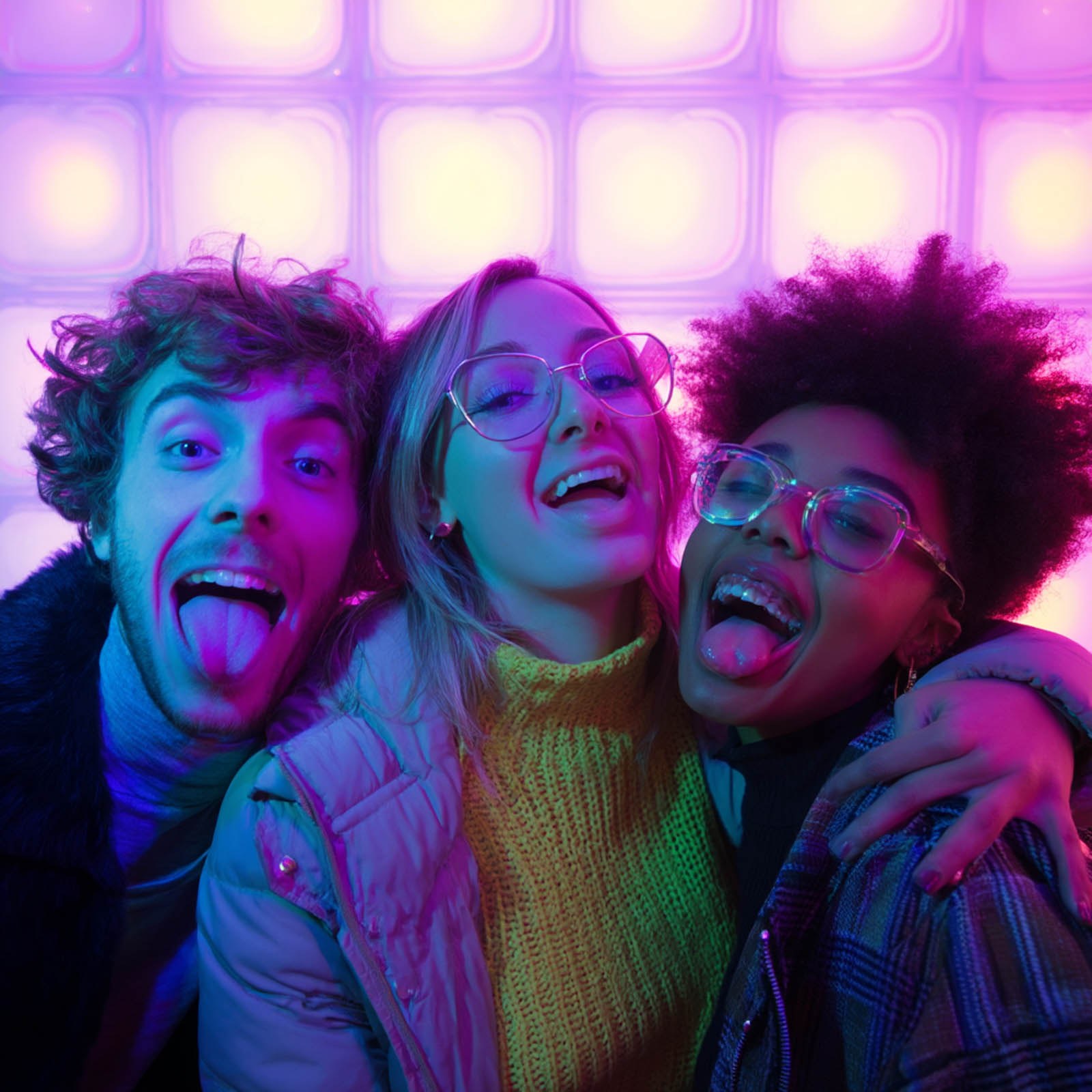 Friends posing in a colorful photo booth