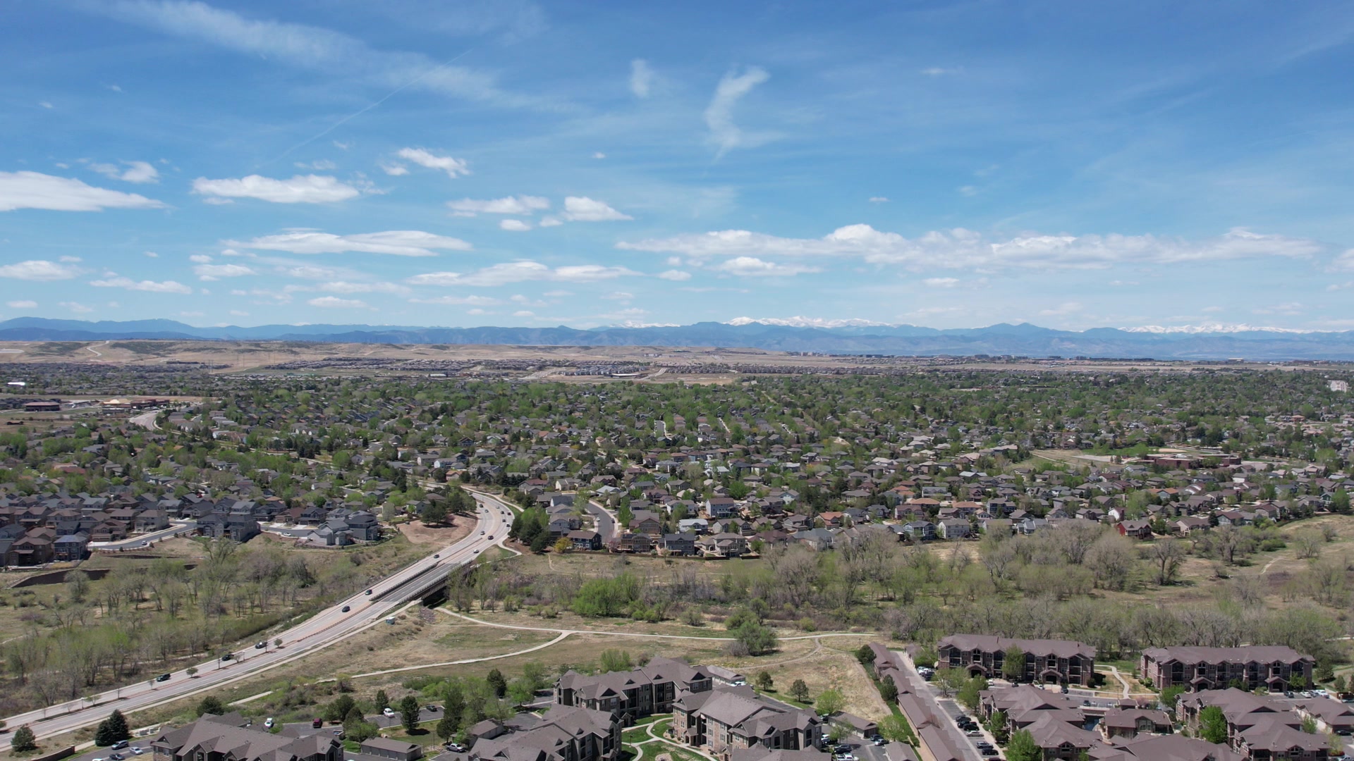 Parker neighborhoods from above with the Front Range on the horizon under a blue sky