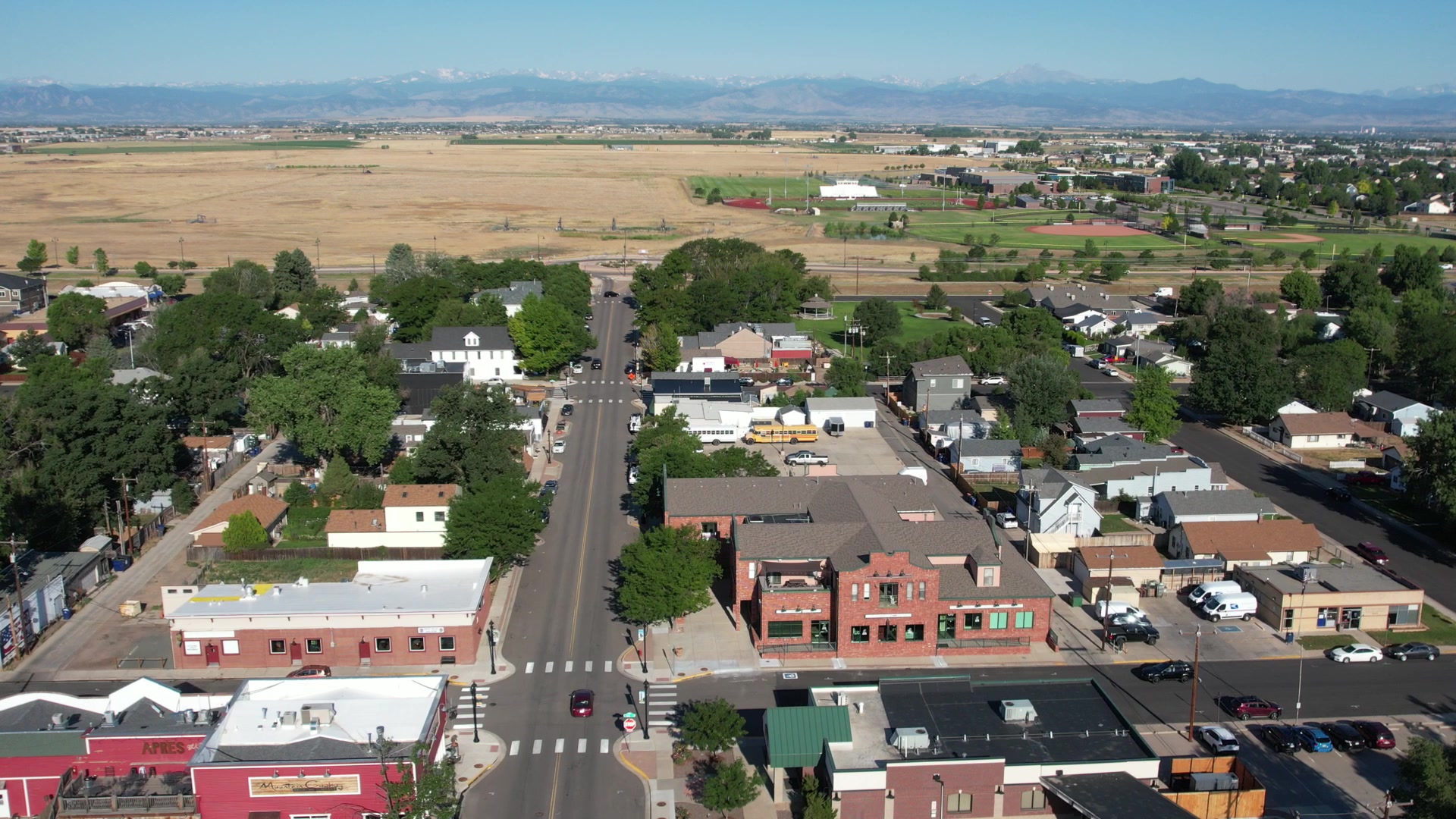 Old-town main street and homes with the Front Range behind