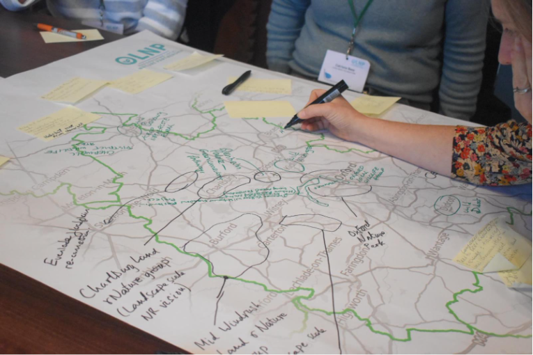 A person writing on a mapAI-generated content may be incorrect.