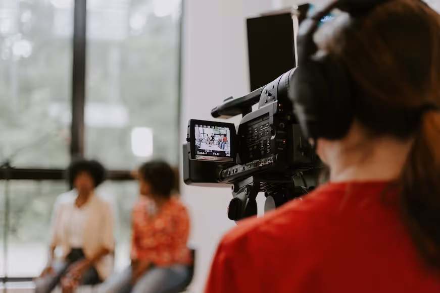 Man filming an event for online broadcasting