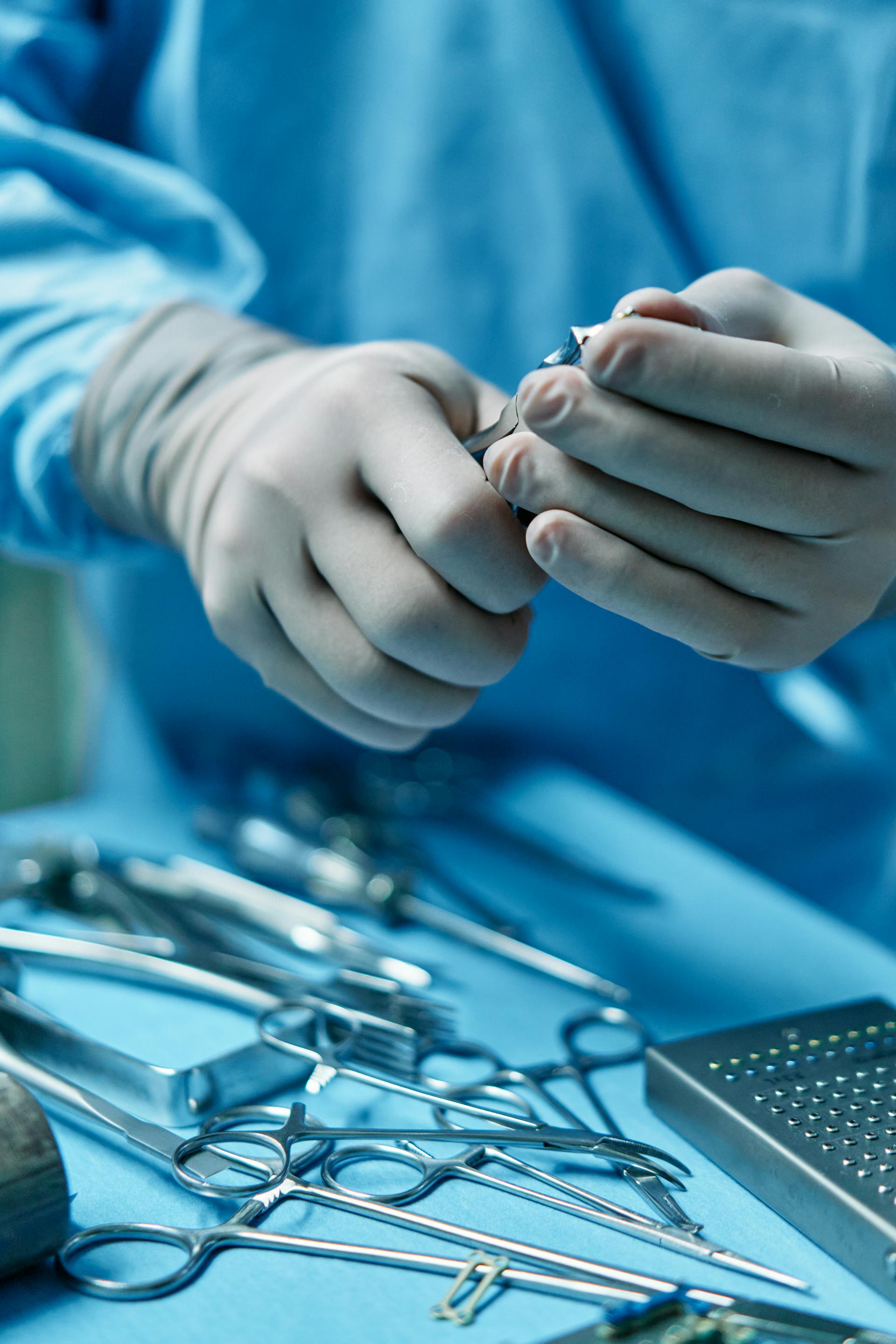 doctors hands holding surgical implements