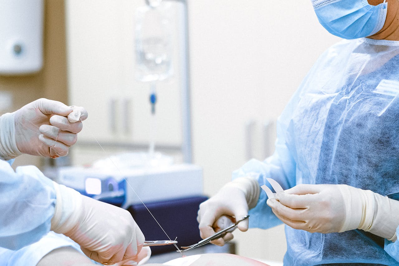 Surgeons cutting stitches 