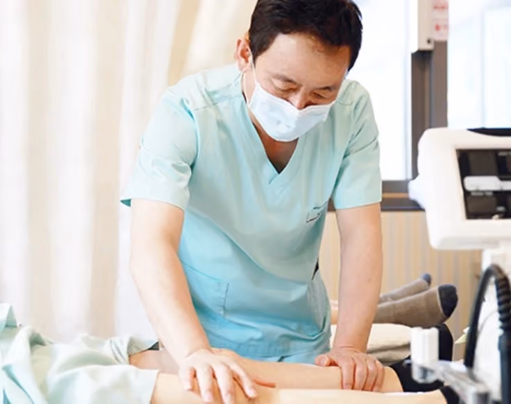 Therapist carrying out hands-on physical therapy on a patient's leg