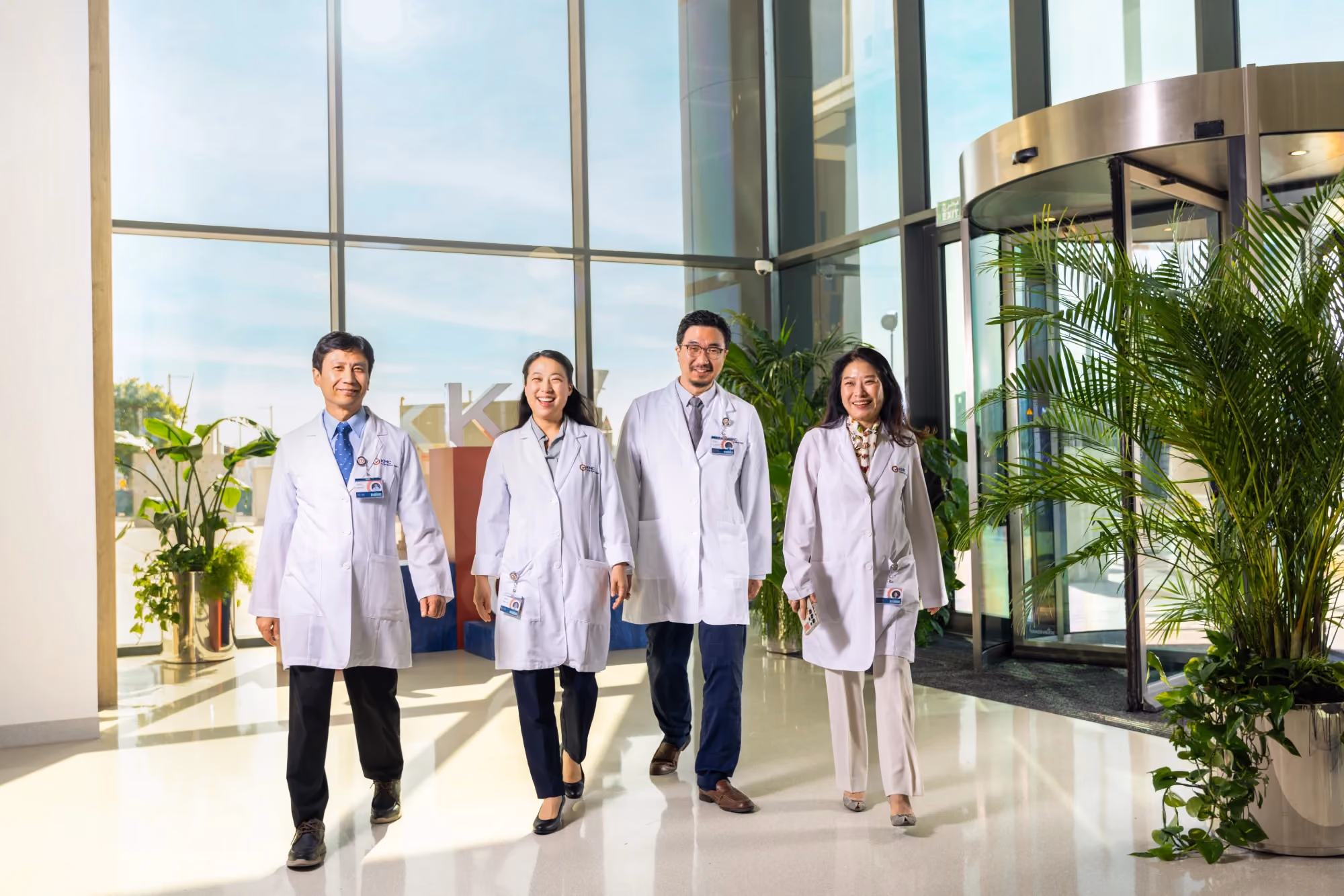 Multidisciplinary team of KMC doctors walking through the centre's main lobby