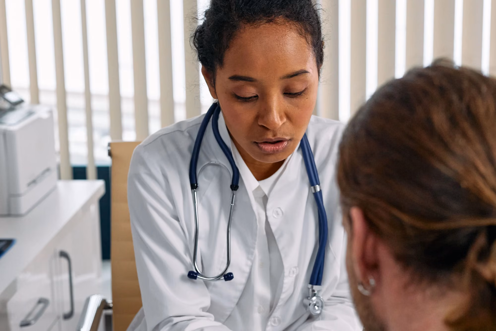 Doctor and patient reviewing a health chart together during a clinic consultation