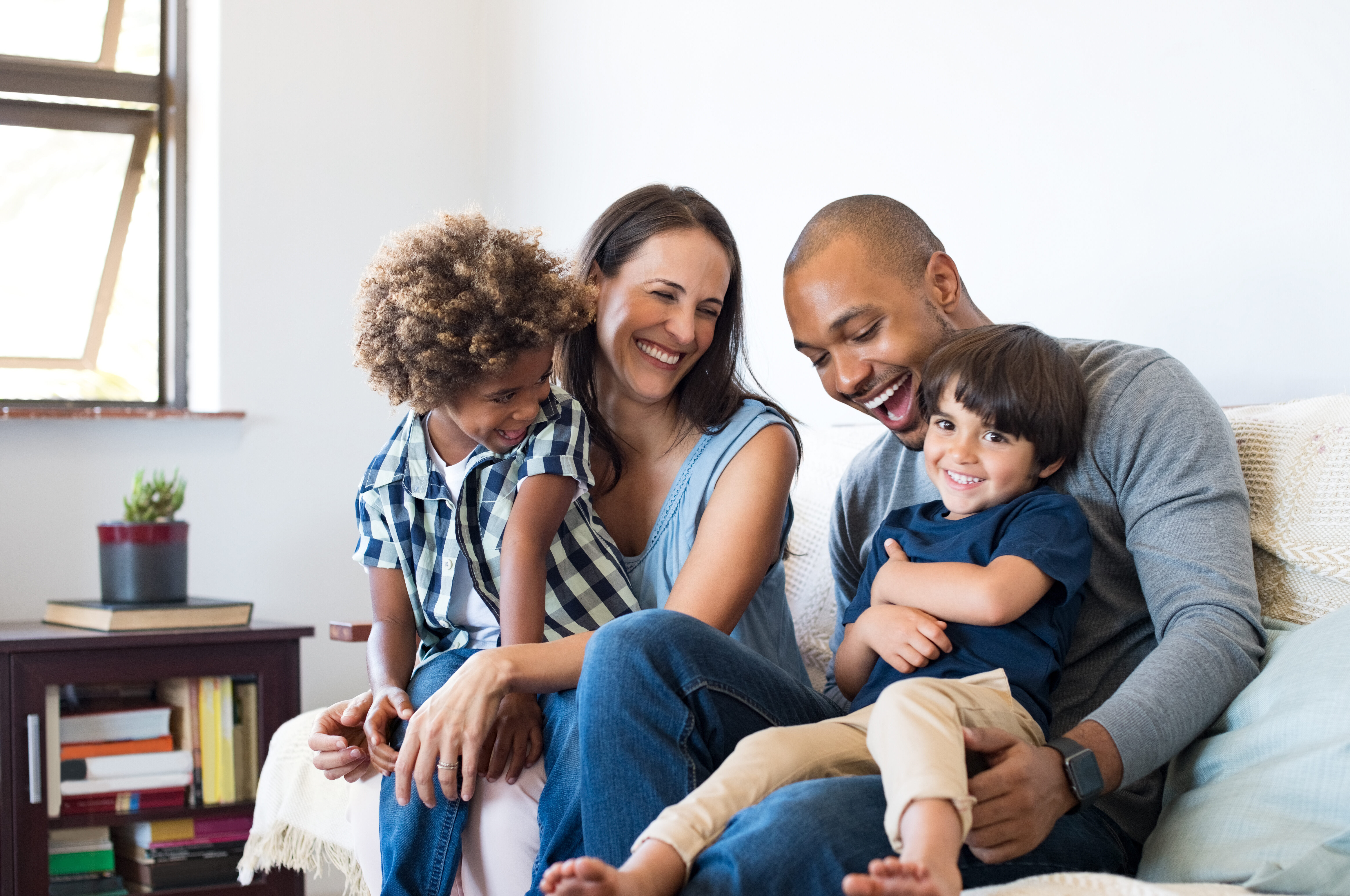 family laughing and smiling on couch stock image
