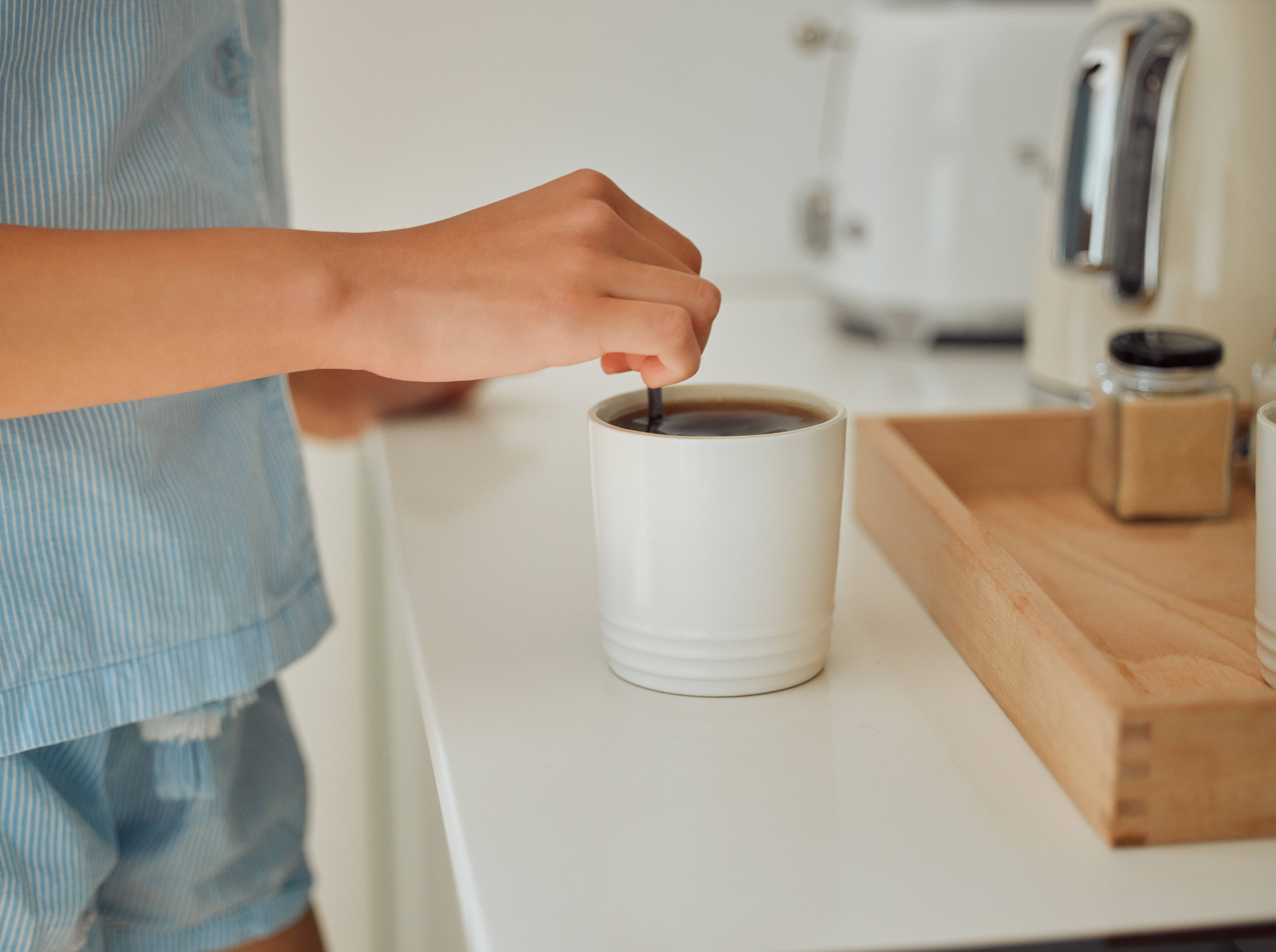 man stirring coffee on counter stock image