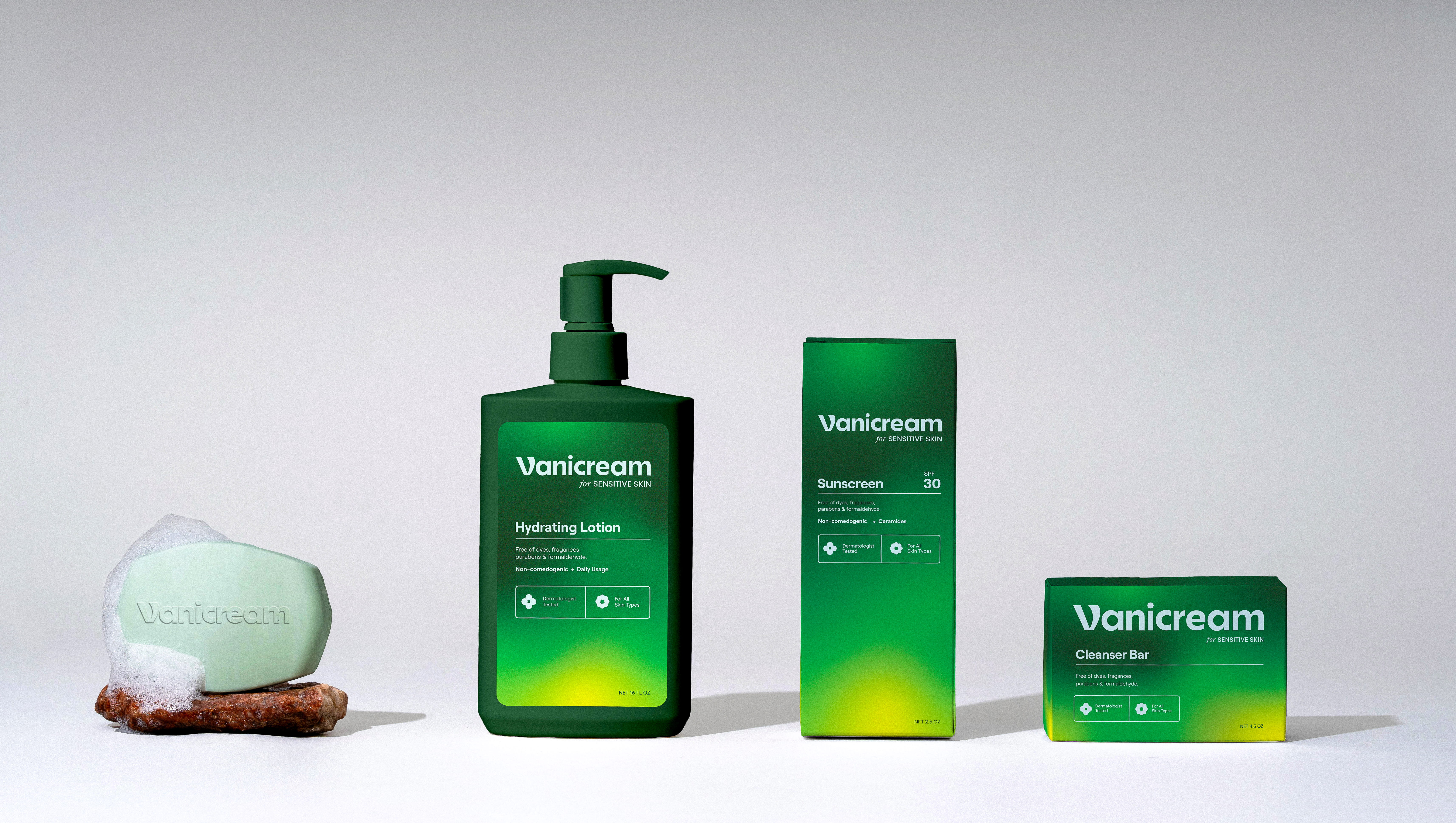 Vanicream skincare products including a foaming bar soap, hydrating lotion pump bottle, sunscreen box, and cleanser bar box on white surface behind a white background.