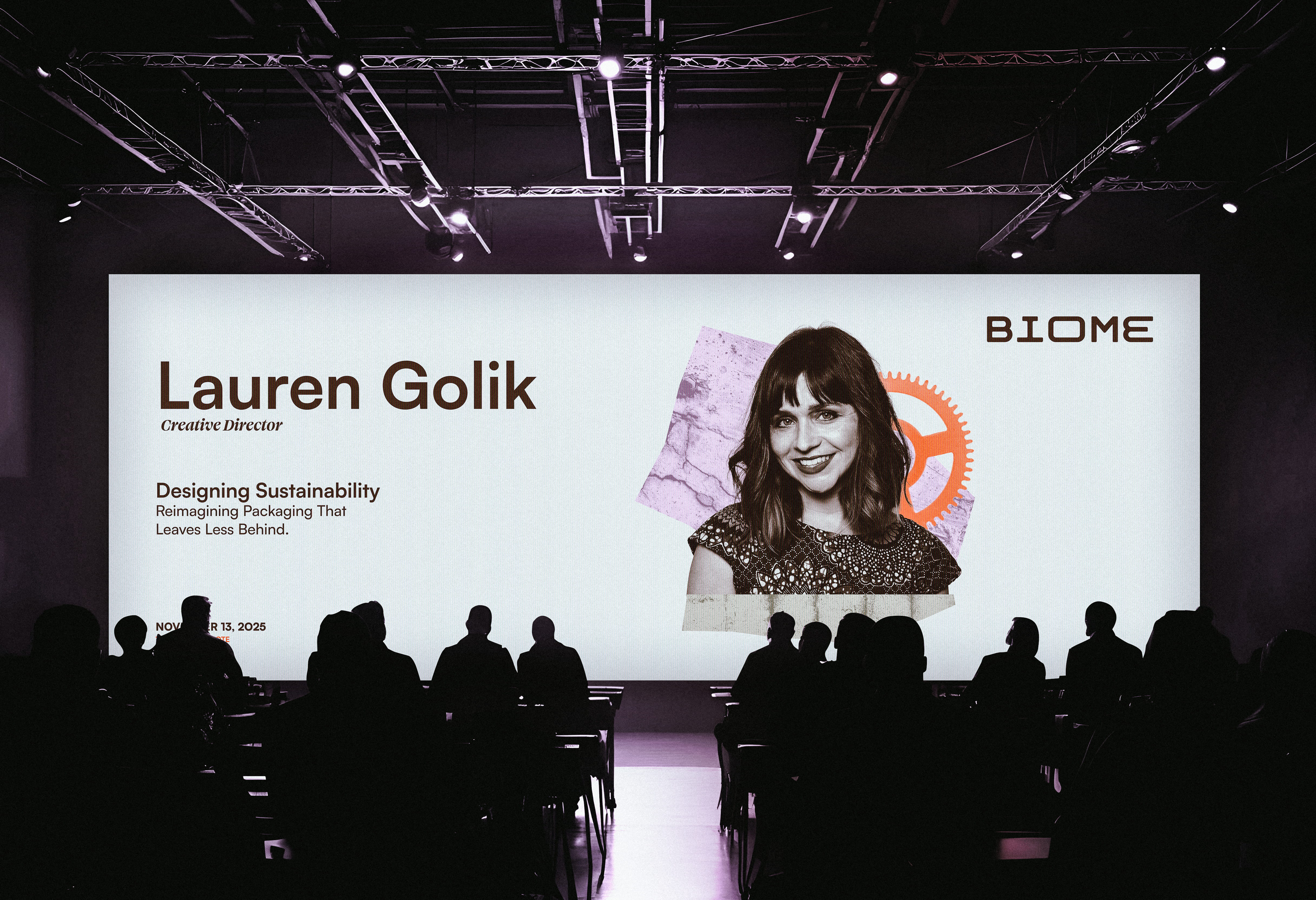 Conference audience watching a presentation slide featuring Lauren Golik, Creative Director, on Designing Sustainability with a photo of her and the logo BIOME.