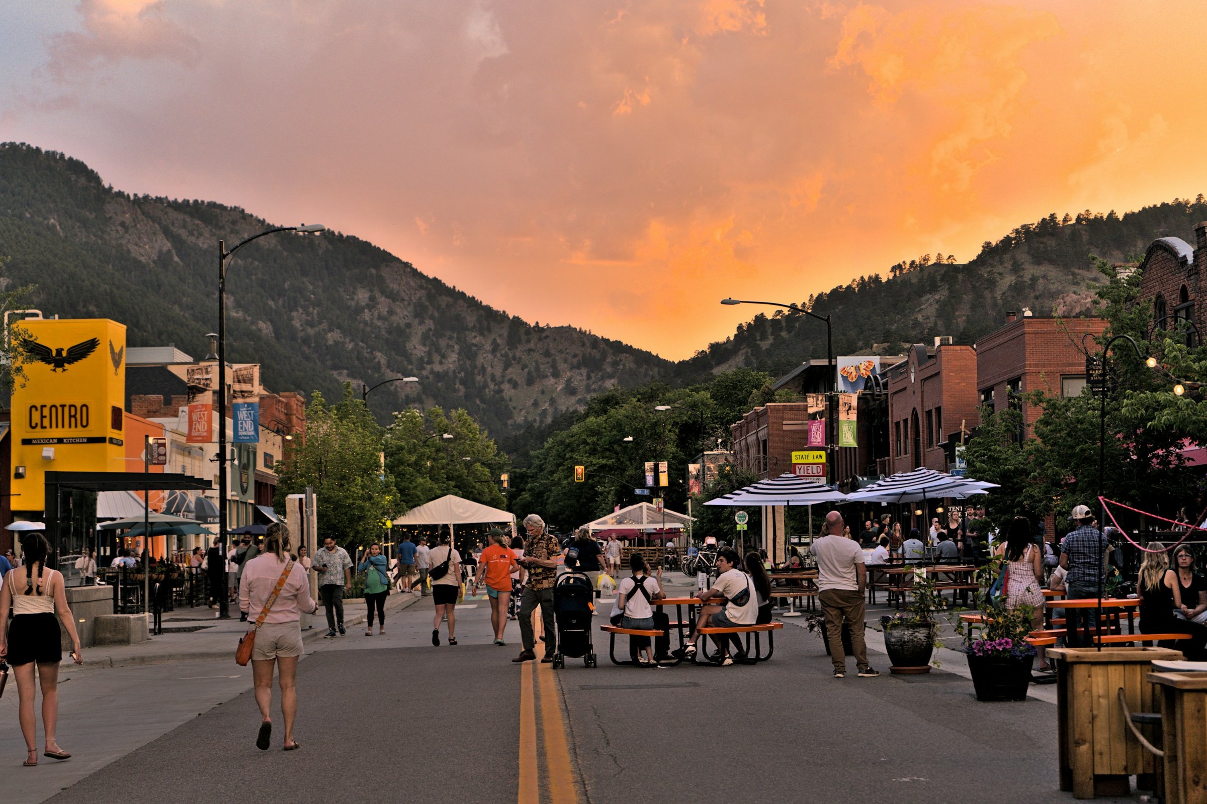 Pedestrians and outdoor dining on Pearl Street in Boulder, Colorado at sunset