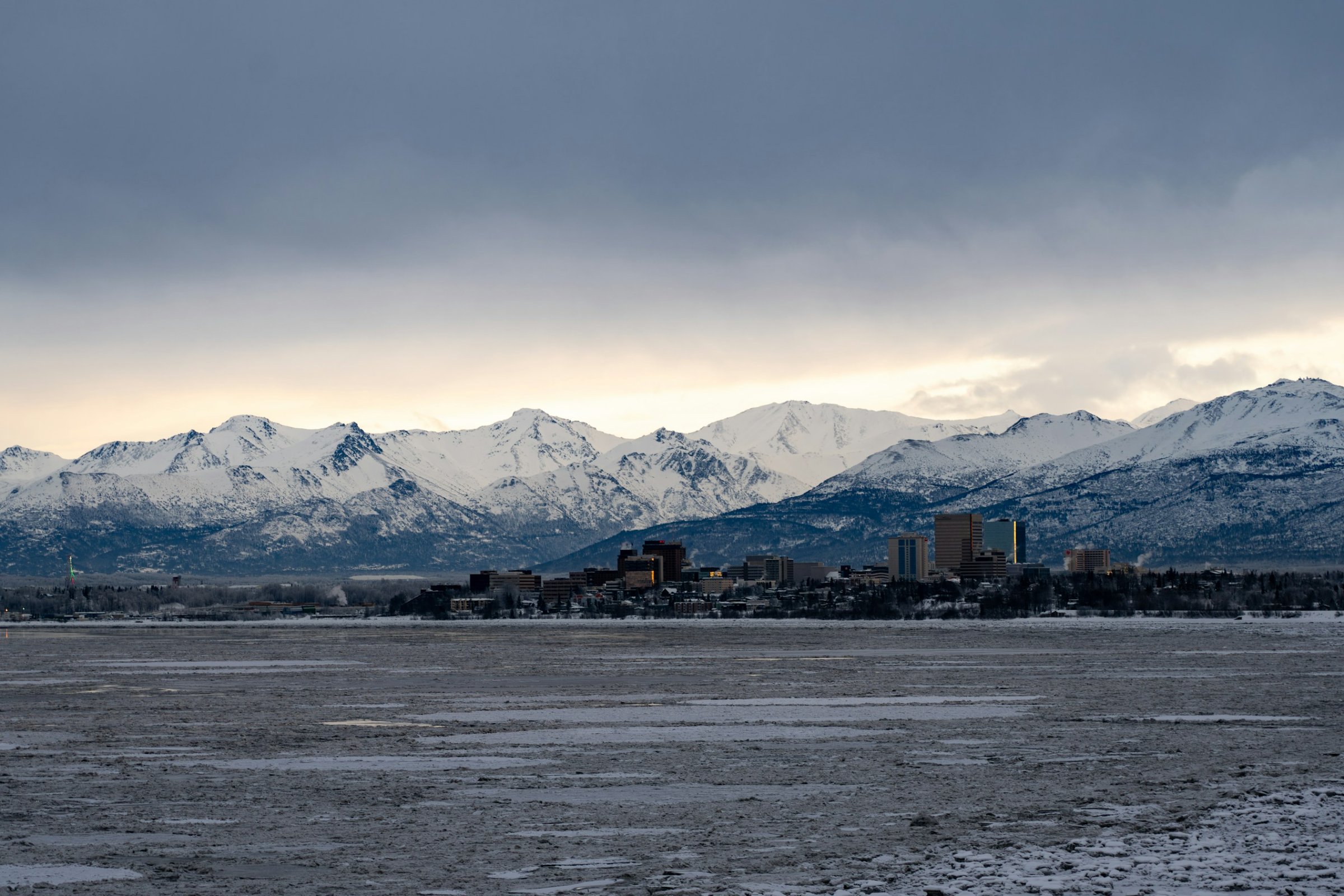 Downtown Anchorage, Alaska skyline beneath snow-capped mountains