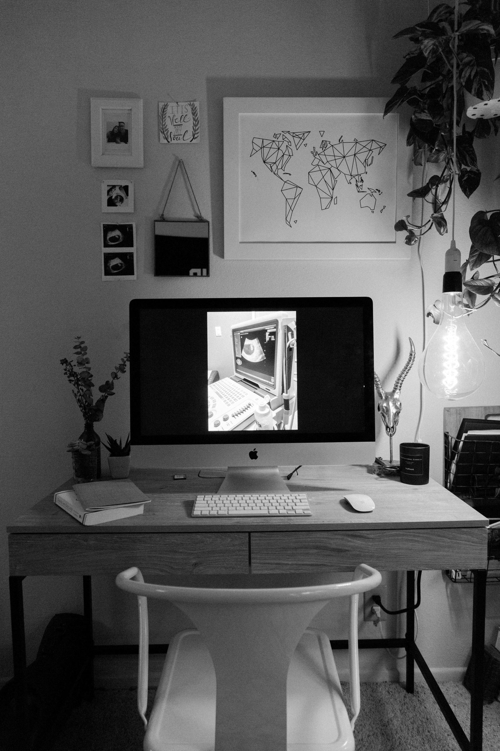 black and white photo of computer on desk