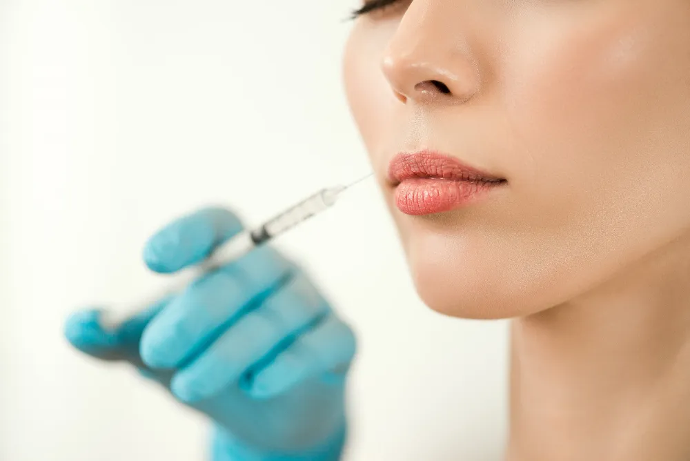 woman receiving a cosmetic lip filler injection from newday medspa