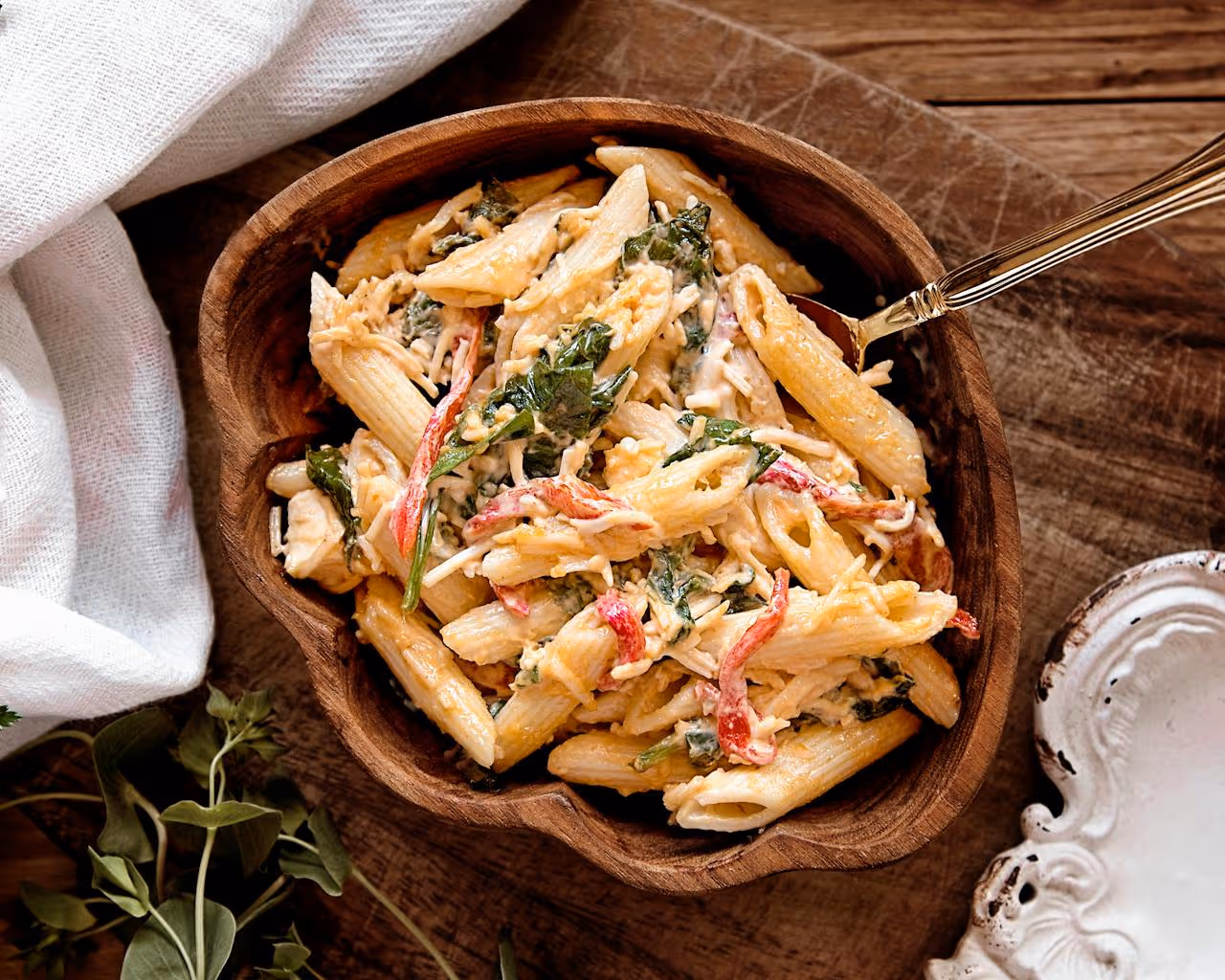 A bowl of pasta with a fork in it.