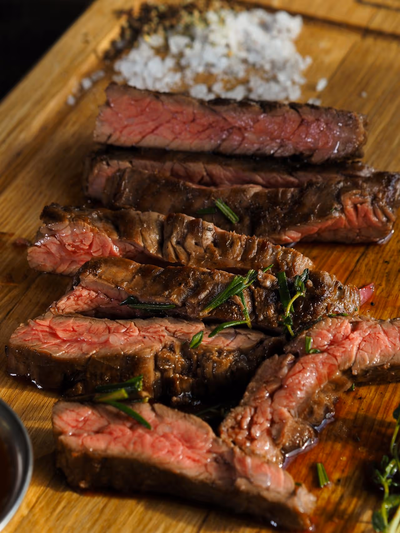 A close up of a piece of meat on a wooden cutting board.