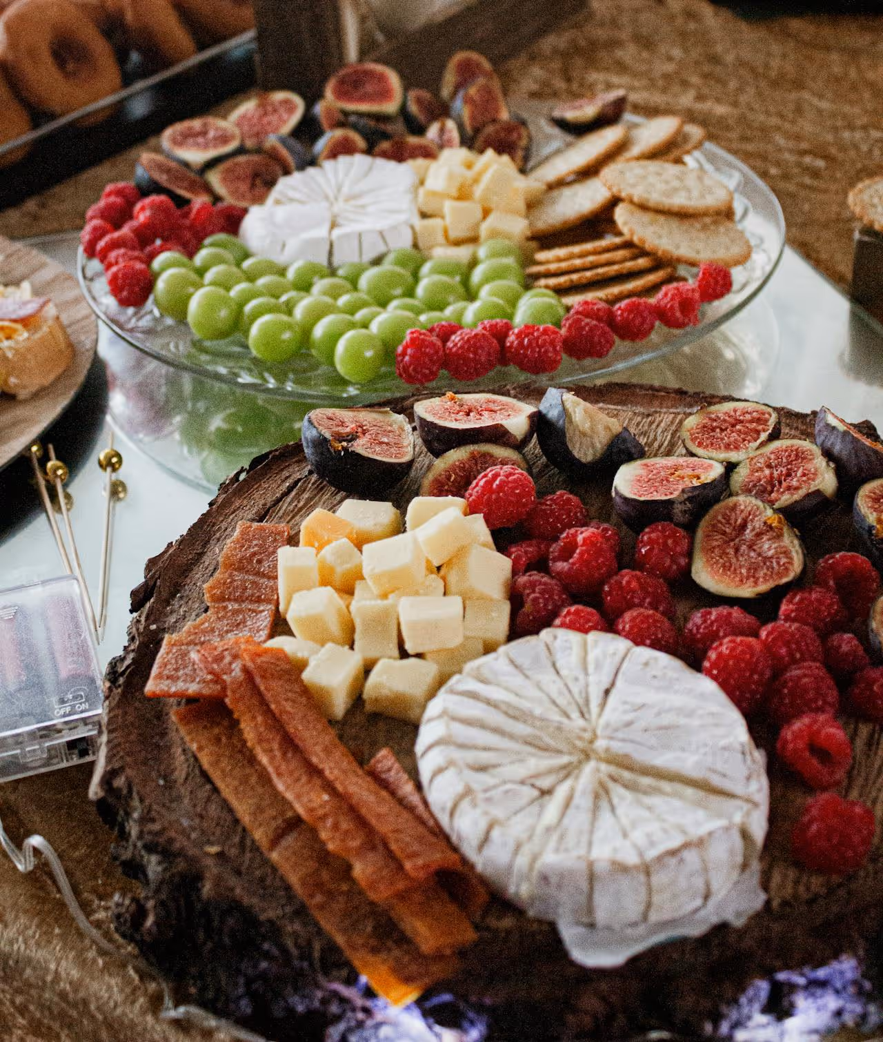 A cheese board with a variety of cheeses and fruit.