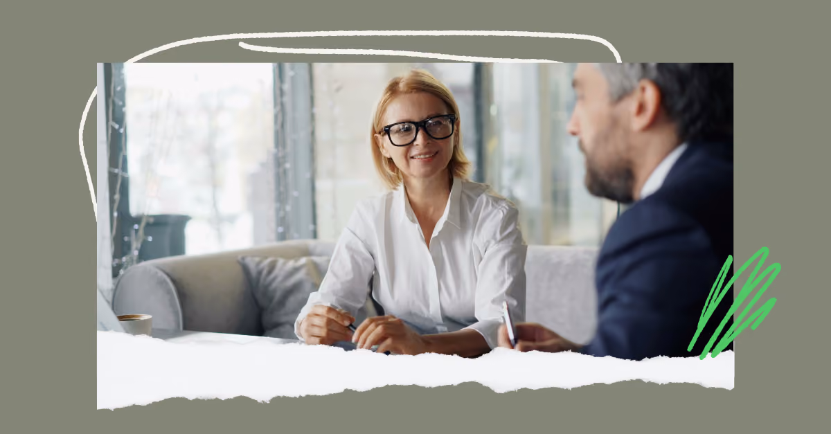 A manager and employee in a calm, one-on-one conversation on a sofa discussing the 360 feedback analysis.