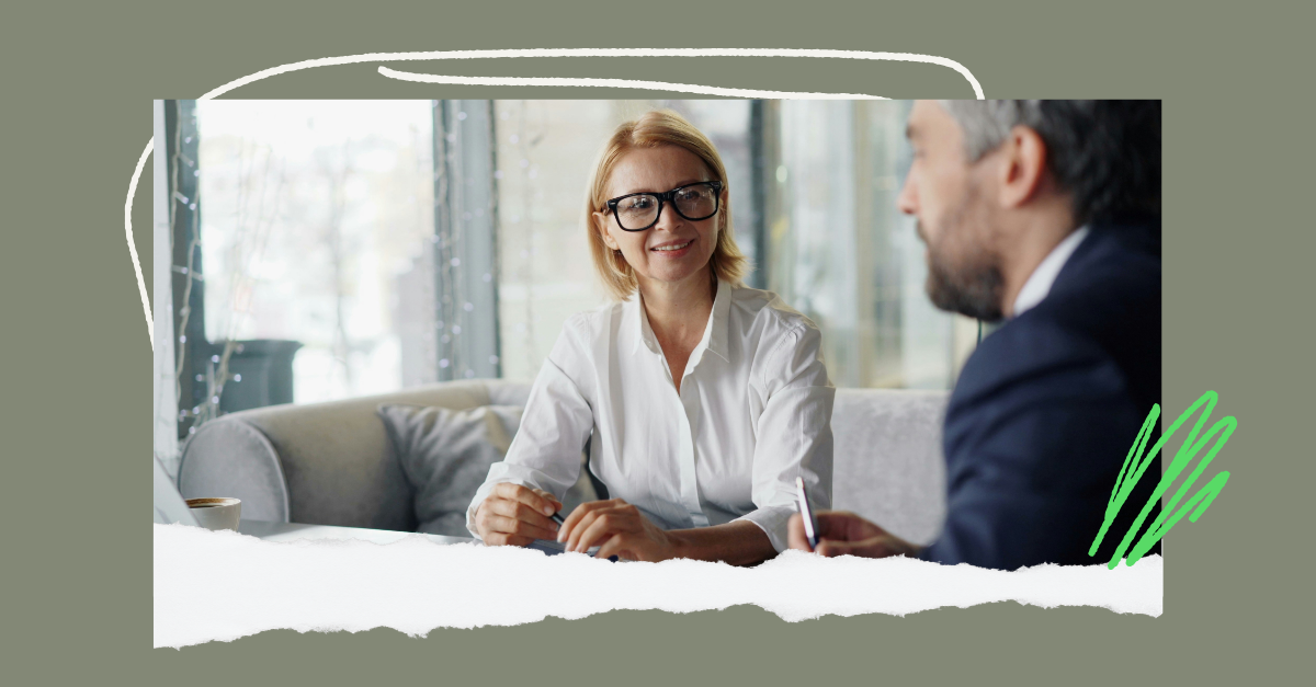 A manager and employee in a calm, one-on-one conversation on a sofa discussing the 360 feedback analysis.
