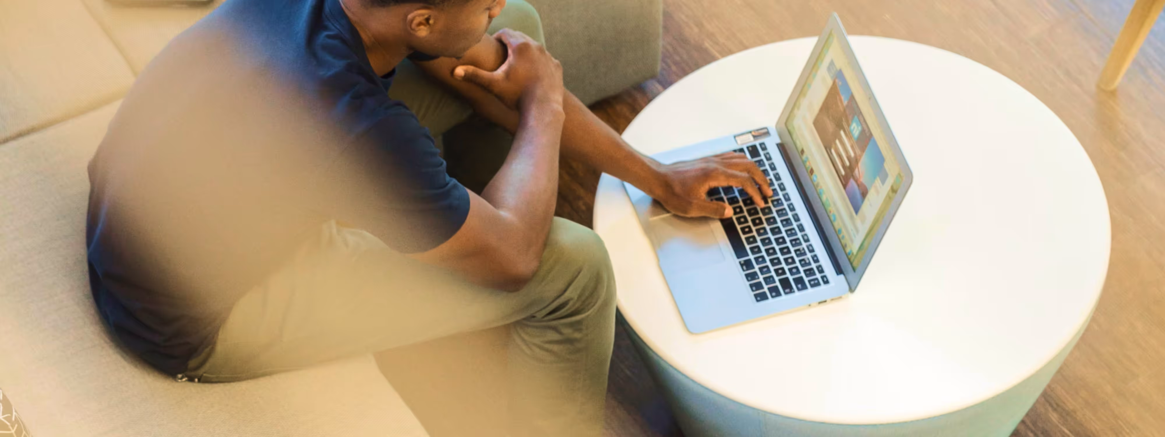A person working on a laptop in a well-lit office space