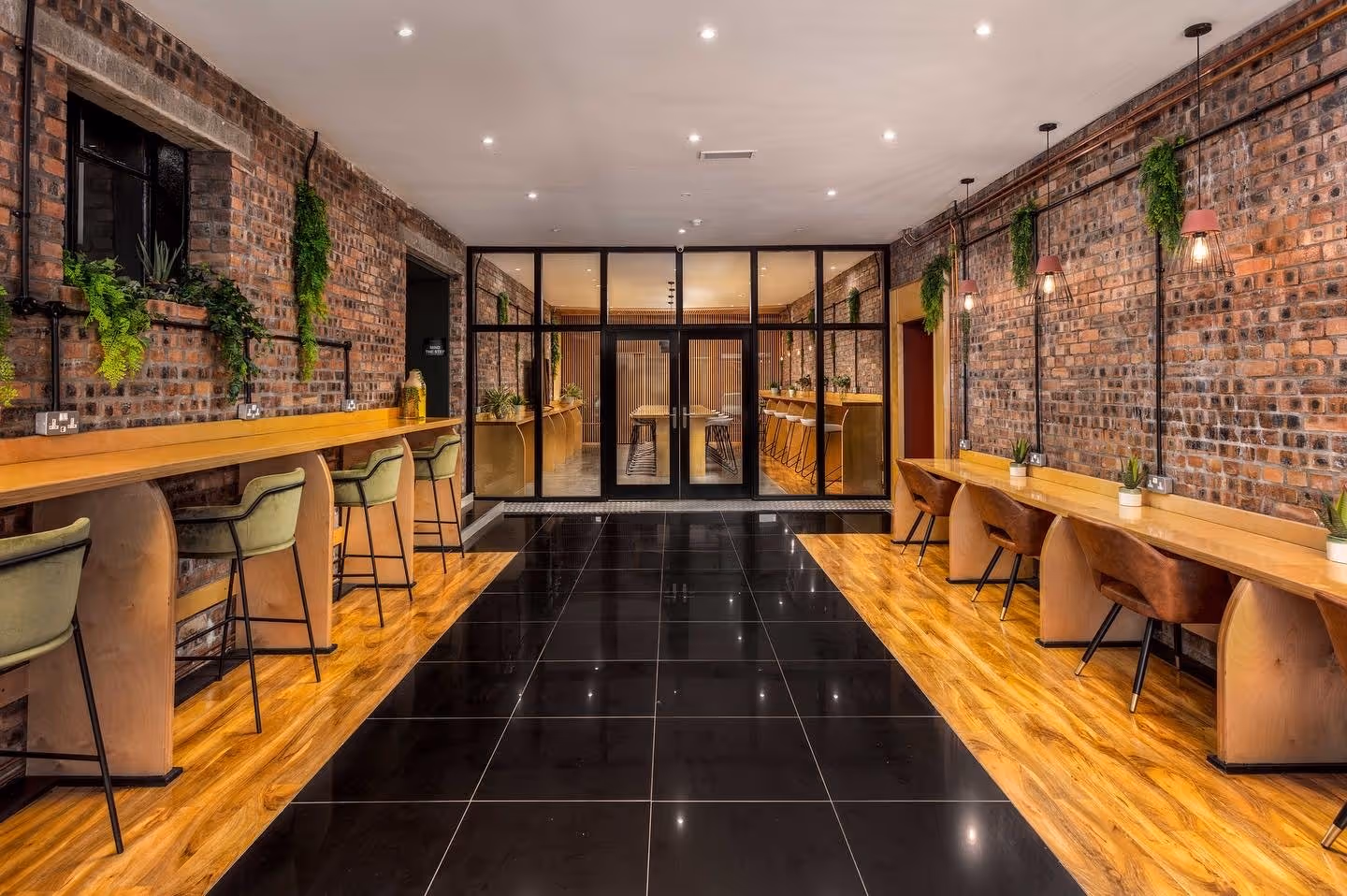 Inviting lounge space with plush seating and indoor plants, promoting relaxation and collaboration.