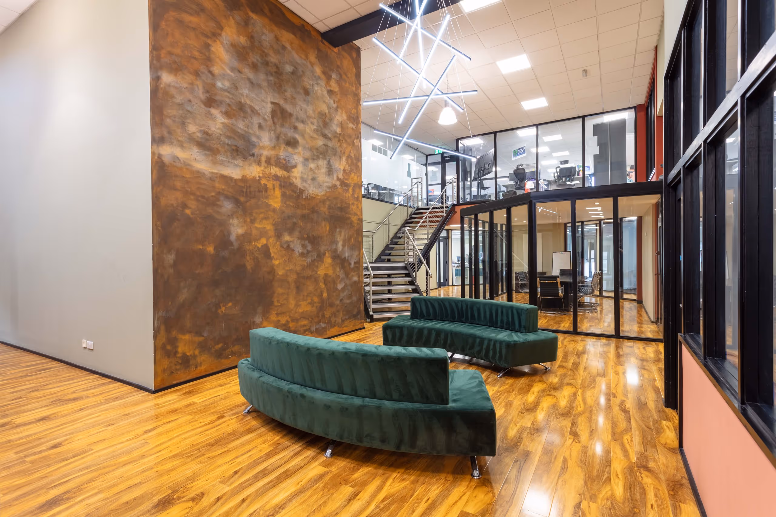 A modern, open-plan coworking breakout space in Corespace Kilmarnock with large windows and contemporary furniture