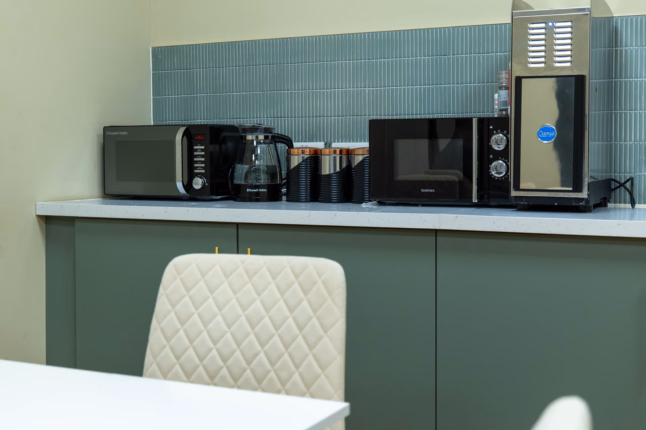 A closeup shot of a modern green kitchen at Corespace
