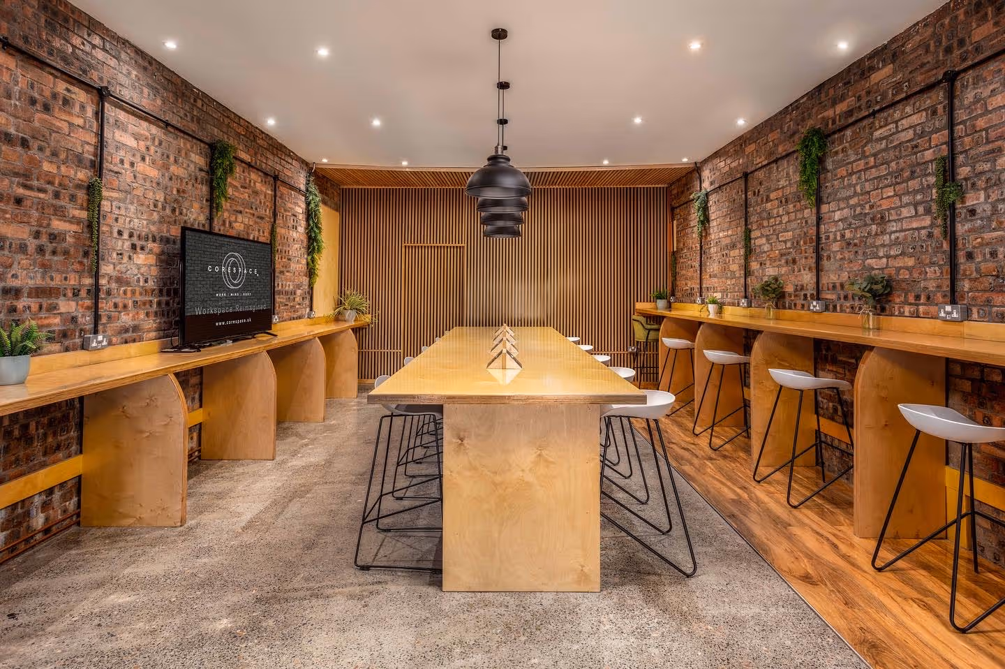 A sleek meeting room at Corespace Ayr with a large table and minimalist decor.
