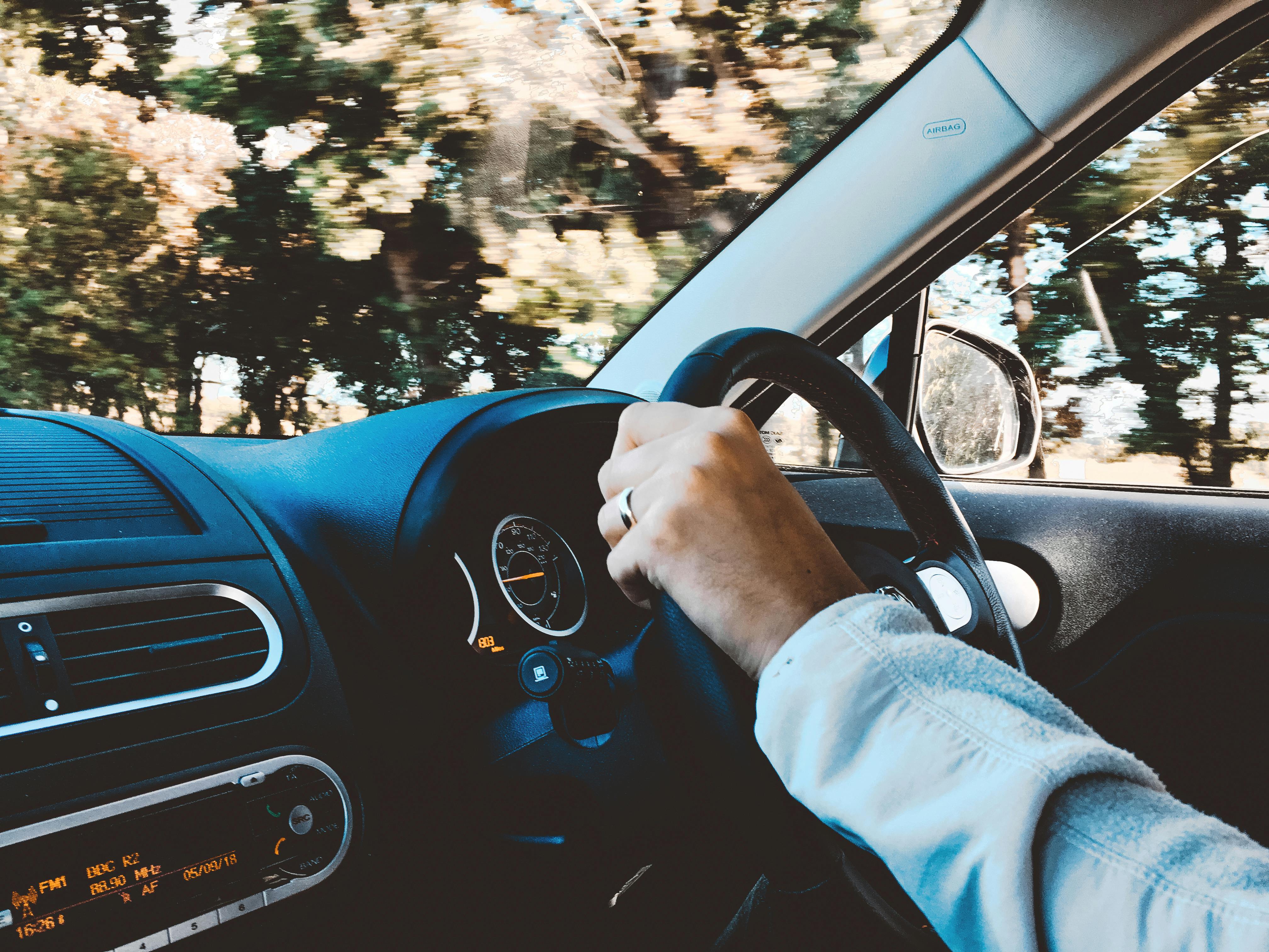 A closeup of a professional driving a car to work