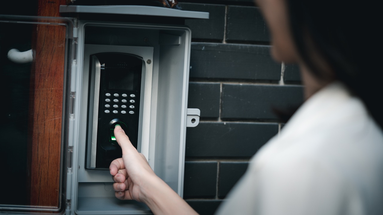 A closup of a woman accessing a secure building using a security system