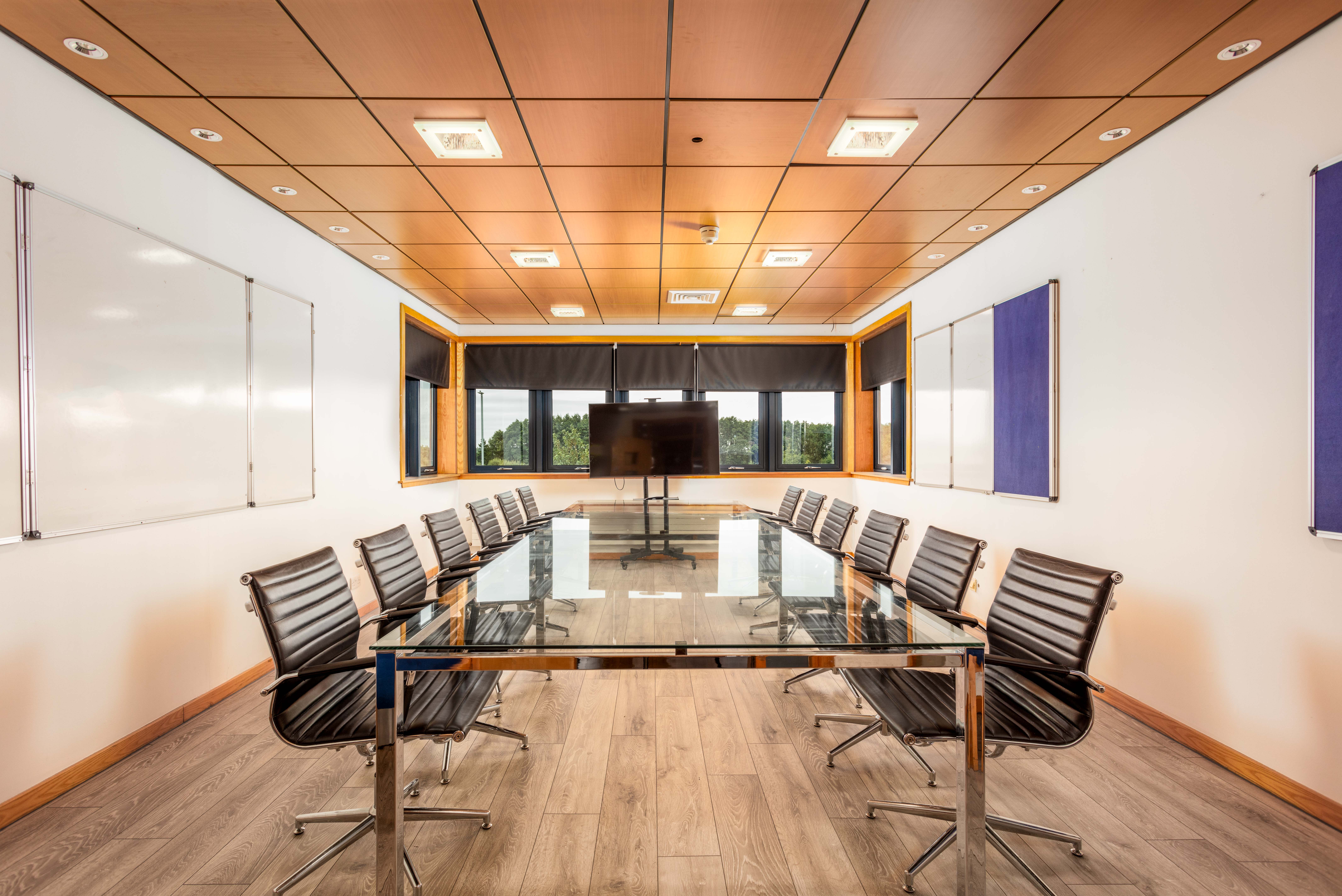 Professional meeting room equipped with a long conference table and minimalist design elements at Corespace Kilwinning