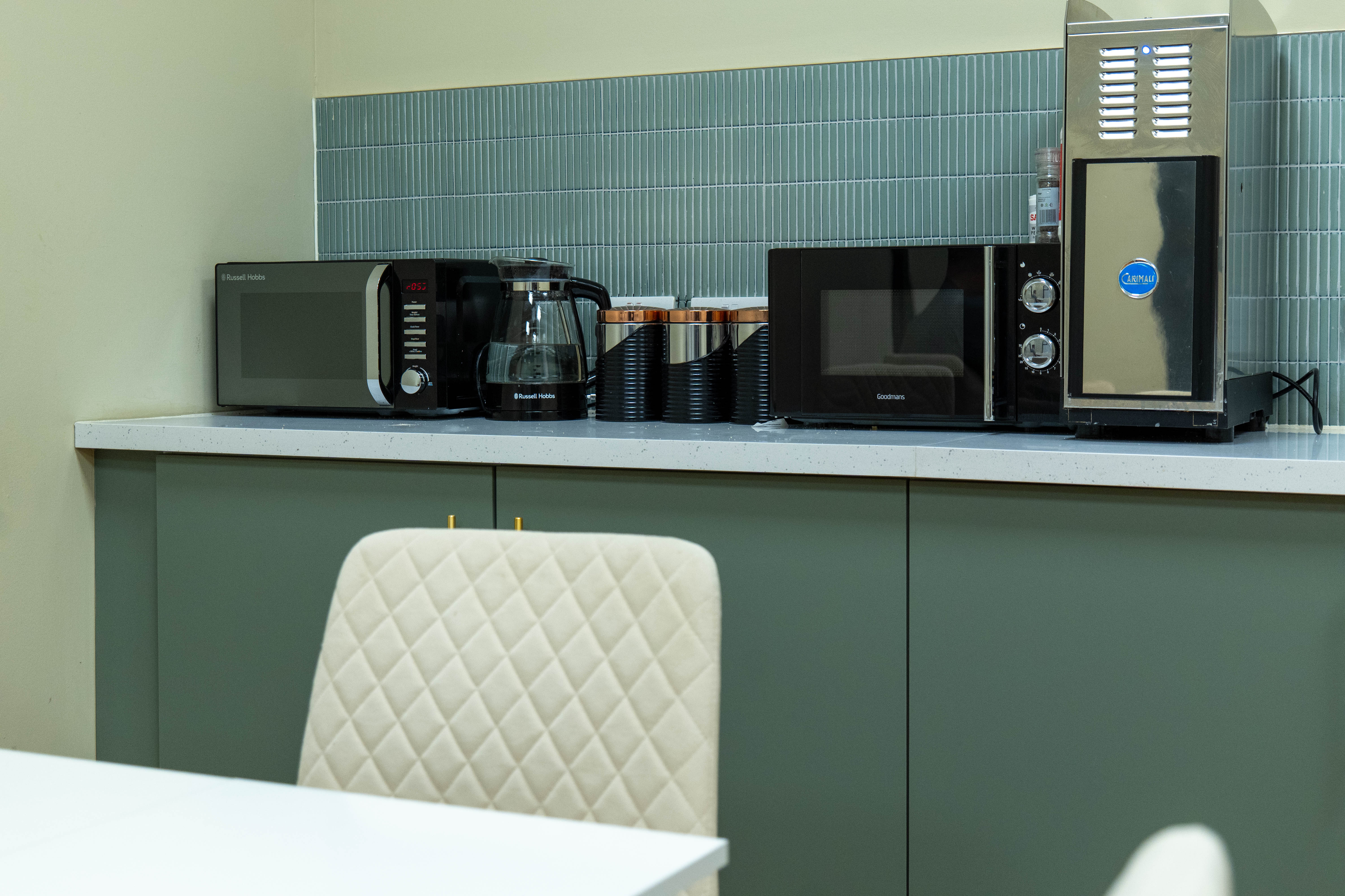 A closeup shot of a modern green kitchen at Corespace