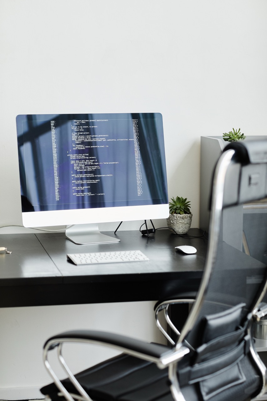 a closup of a computer IT support desk with a chair 