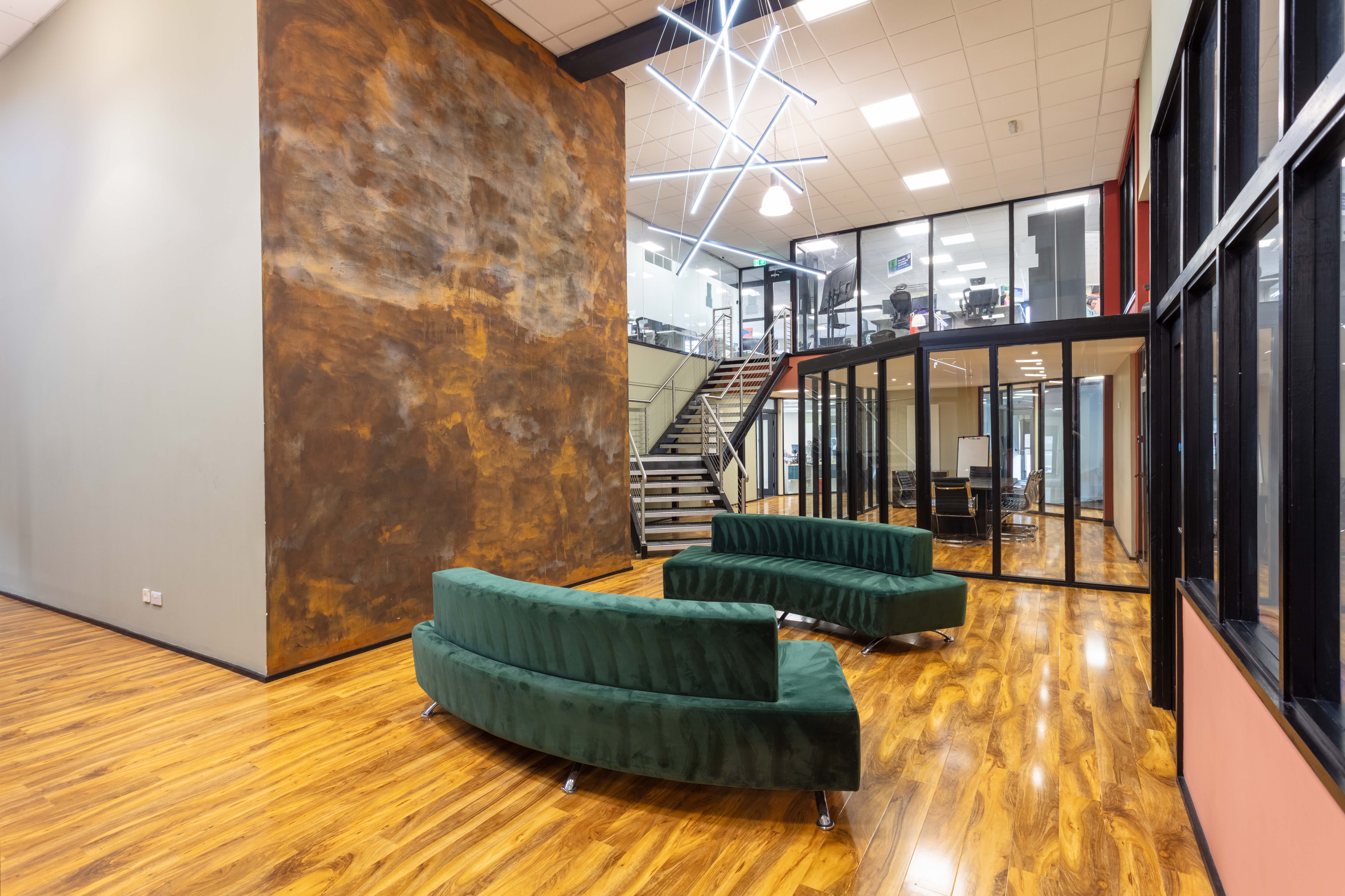 A modern, open-plan coworking breakout space in Corespace Kilmarnock with large windows and contemporary furniture