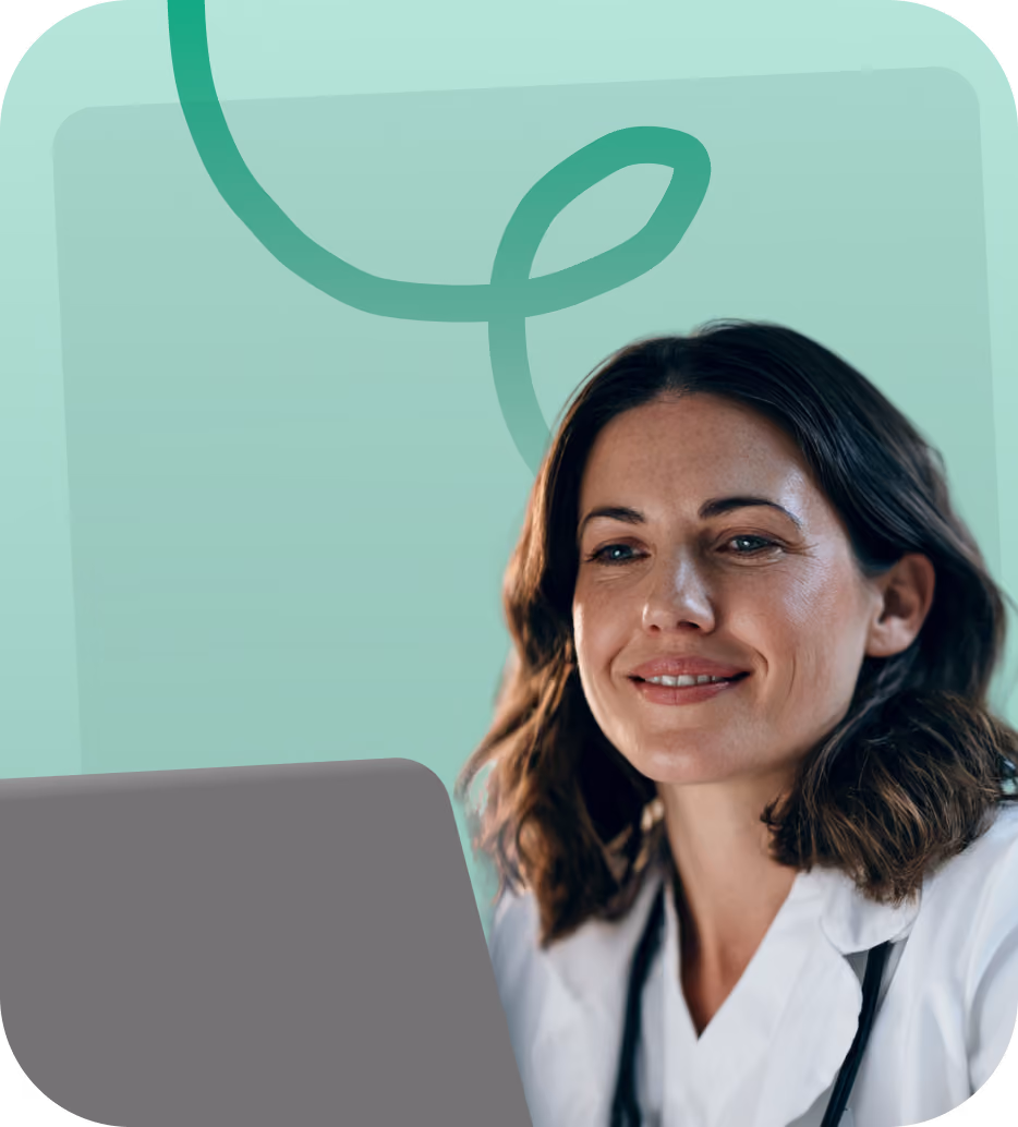 Doctor smiling behind a laptop