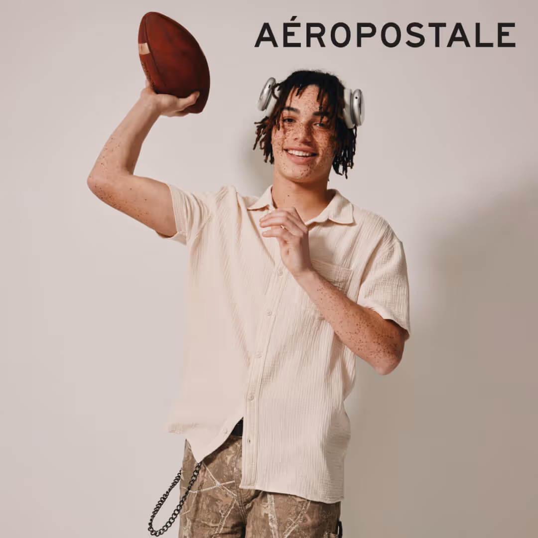 Model wearing Aeropostale apparel throwing a football