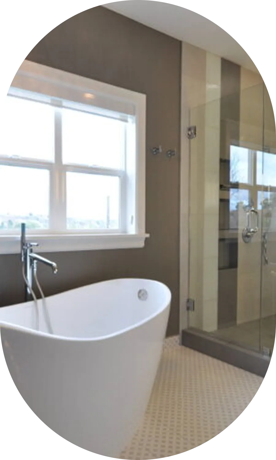 Remodeled bathroom with a freestanding tub and glass-enclosed shower