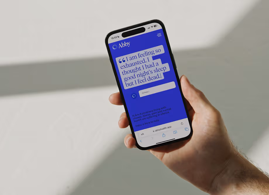 Hand holding smartphone displaying a health app with text about feeling exhausted despite sleep.